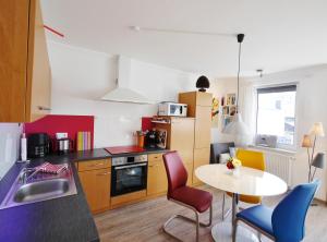 a kitchen with a table and chairs and a table and a table and chairsktop at Fewo Penthaus-Blick in Willingen