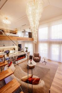 a living room with a chandelier and a living room at Quinta Linhas da Primavera in Guimarães