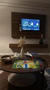 a room with a table with a tv on a wall at شقة غرفة وصالة مريحة in Jeddah