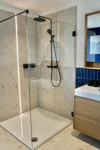 a shower with a glass door in a bathroom at SmartStay in Gronau +40 photos