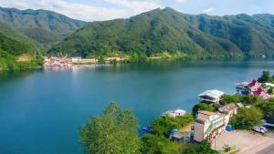 an aerial view of a lake with mountains in the background at Gapyeong Elin Pension in Gapyeong