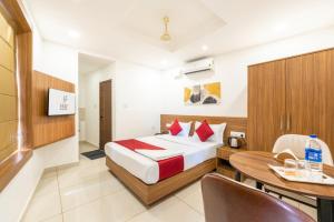 a hotel room with a bed and a dining table at Hotel Faaz international in Thottada +48 photos