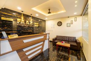 a waiting room with a couch and a table at Hotel Faaz international in Thottada