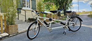 a bike parked on the street in front of a house at Le beloiseau in Breteuil +18 photos