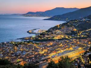 an aerial view of a city next to the water at Athena in Camporosso