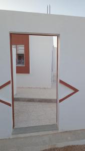 an open door into a room with a mirror at Najib in Djerba