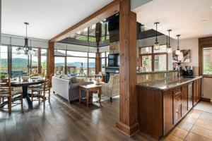 a kitchen and living room with a table and a dining room at Tremblant Prestige - Altitude 170-1 in Mont-Tremblant
