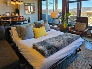 a large bed in a room with a large window at Tremblant Prestige - Altitude 170-1 in Mont-Tremblant