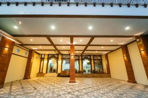 an empty lobby of a building with a tile floor at Bintang Samudra Hotel in Jepara