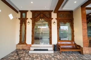 a room with a wooden bench in front of a store at Bintang Samudra Hotel in Jepara