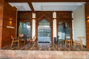 a room with chairs and tables in a building at Bintang Samudra Hotel in Jepara +14 photos