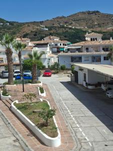 arial view of a parking lot with palm trees and buildings at El Paraíso del Tesorillo in Almuñécar +3 photos