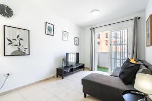 a living room with a couch and a tv at La Posadilla in Adeje +2 photos