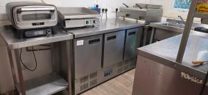 a kitchen with a microwave and acomputer on a counter at Cabin - Sleeps 2 hot tub & parking in Welshpool