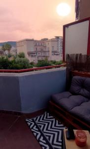 a balcony with a couch and a view of a city at Casa Lupoli in Caserta