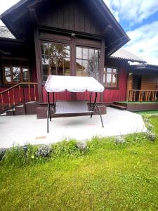 a picnic table in front of a house at Mover mount apart in Skole