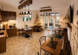 a kitchen and dining room with tables and chairs at Family ЛюКс in Kamianets-Podilskyi