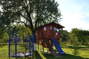 a playground with a tree house and a slide at Ograda Bunicilor Sarata in Sărata