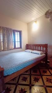 a bedroom with a large bed with stars on the floor at Verdant Vagamon Cottage in Vagamon