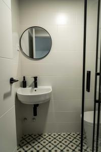 a bathroom with a sink and a mirror at El Convento in Molina de Aragón