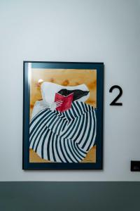 a framed picture of a dress with a red bow tie at El Convento in Molina de Aragón