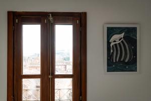 an open door with a picture next to a window at El Convento in Molina de Aragón