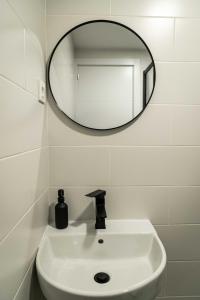 a bathroom with a mirror and a sink at El Convento in Molina de Aragón