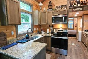 a kitchen with a sink and a stove top oven at Amazing Mountain View Tiny House in Hayesville