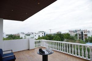 a balcony with a view of a city at The Woods by CASA D' GAVA in Lucknow