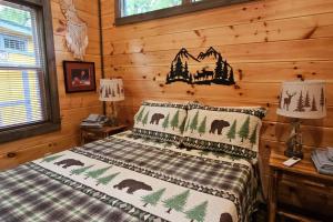 a bedroom with a bed in a log cabin at Amazing Mountain View Tiny House in Hayesville