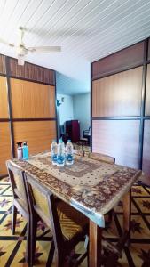 a table with water bottles sitting on top of it at Verdant Vagamon Cottage in Vagamon +28 photos