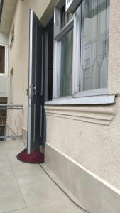 an open door of a building with a window at Anas apartments in Zugdidi