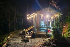 a small house with lights on it at night at Amazing Mountain View Tiny House in Hayesville
