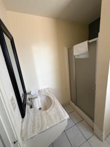 a bathroom with a sink and a shower at Cinderella Motel in Wasco