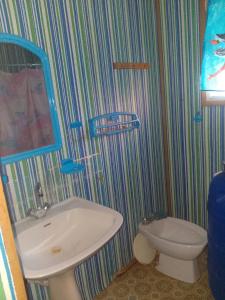 a bathroom with a sink and a toilet at Mobil-home in Rebaïb