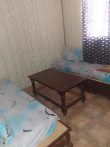 a room with two twin beds and a table at Mobil-home in Rebaïb