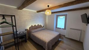 a bedroom with a bed and a television in it at Ca' Mariuccia in Crodo