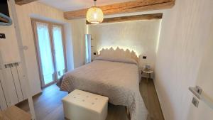 a bedroom with a bed and a large window at Ca' Mariuccia in Crodo