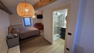 a small bedroom with a bed and a mirror at Ca' Mariuccia in Crodo