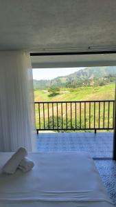 a bedroom with a bed and a balcony with a view at Hotel Catleya Royal Club in Pereira +55 photos