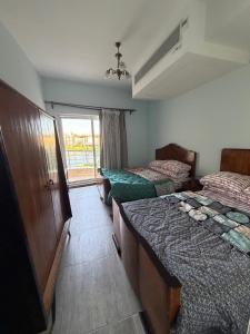 a room with two beds and a window at North Coast sedra resort Villa, قرية سيدرا الساحل الشمالي in Alexandria +44 photos
