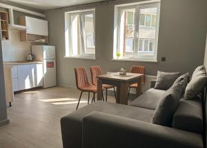 a living room with a couch and a table and a kitchen at Mini home apartment in Ternopil