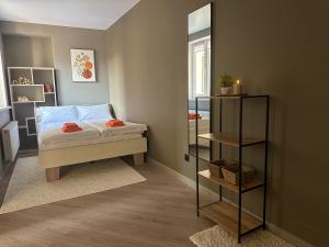 a small bedroom with a bed and a mirror at Mini home apartment in Ternopil