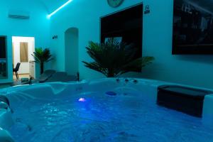 a jacuzzi tub in a room with blue lighting at Luxapartment Jacuzzi with Breakfast option in Košice