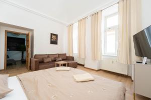 a living room with a bed and a couch at Luxapartment Jacuzzi with Breakfast option in Košice +7 photos