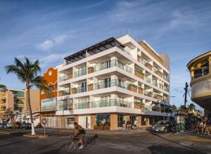 a person riding a bike in front of a building at Hotel Casa Bahía Cozumel - Adults Only in Cozumel