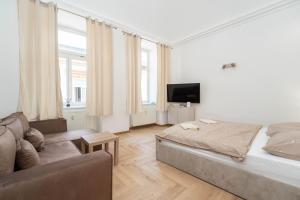 a living room with a bed and a couch at Luxapartment Jacuzzi with Breakfast option in Košice
