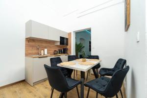 a kitchen and dining room with a table and chairs at Luxapartment Jacuzzi with Breakfast option in Košice