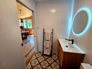 a bathroom with a sink and a mirror and a table at Camping Abenaki Aventure - Les Chalets in Pierreville +42 photos