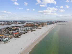 an aerial view of a beach with buildings and the ocean at Coconut Grove Resort in Clearwater Beach